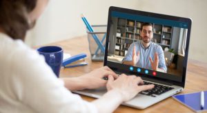 man on laptop virtual interview