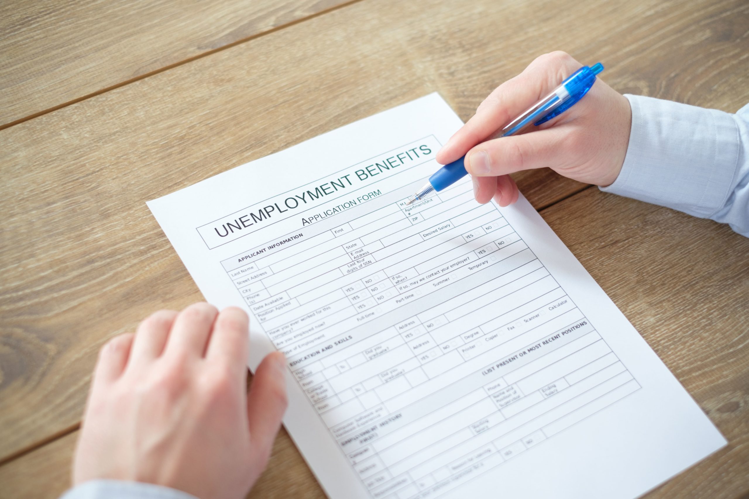 person filling out unemployment document